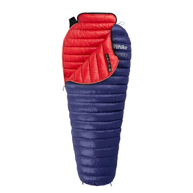An image of Blue Nylon, goose down weather resistant sleeping bag with a red lining, with white backdrop