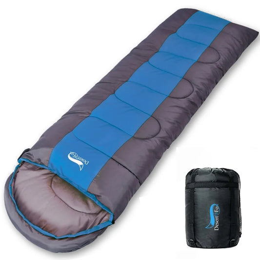 A camping sleeping bag with blue accents on a gray base, displayed next to its compression bag.