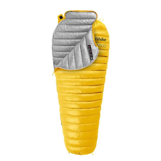 An image of Yellow Nylon, goose down weather resistant sleeping bag with a silver lining, with white backdrop